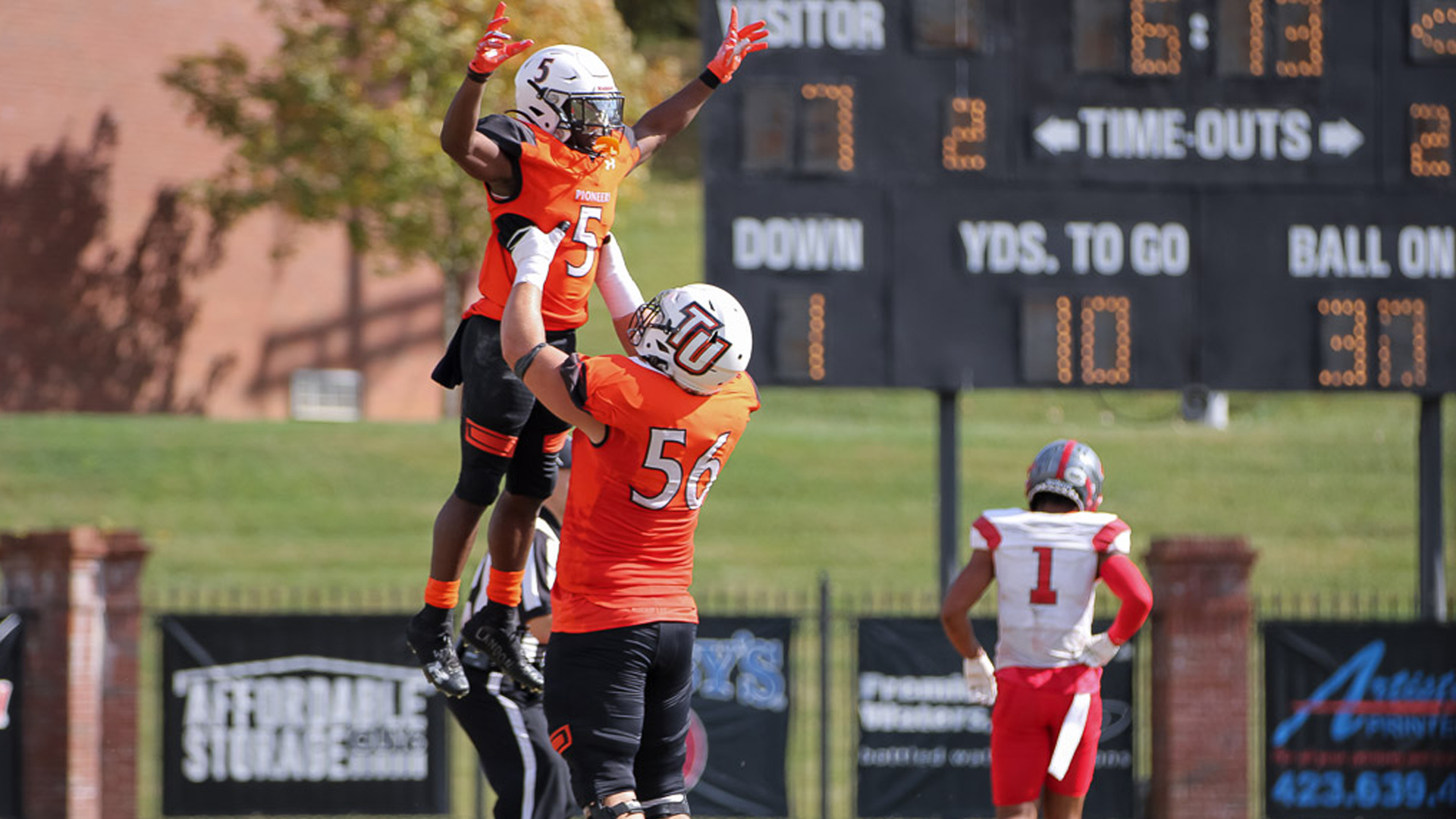 Tyler Burke (5) celebrates with Adrian Gumm (56) following a touchdown in Tusculum's 35-7 win over UVA Wise (photo by Kari Ham).