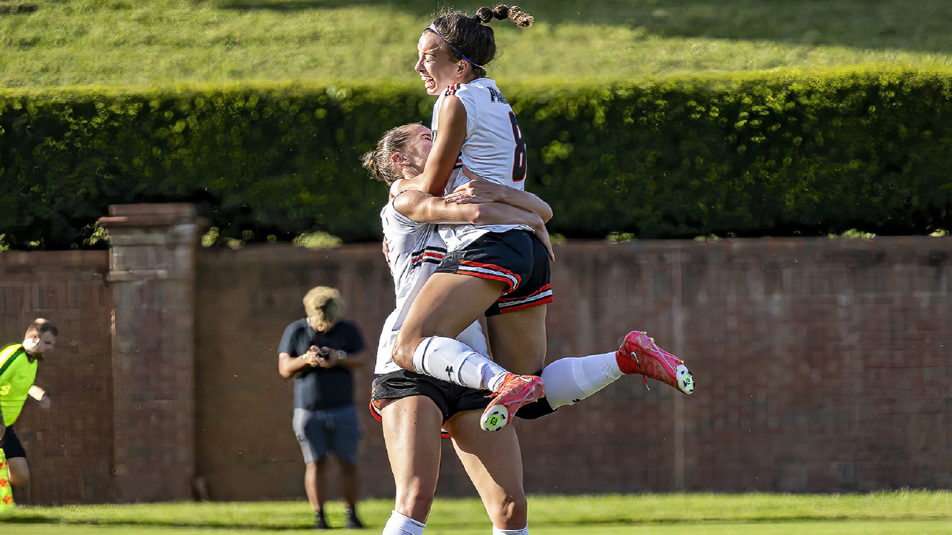 Lakin Pennington leaps in the arms of Sydney Grant after scoring in the first half for a 2-0 Pioneer lead (photo by Chuck Williams)