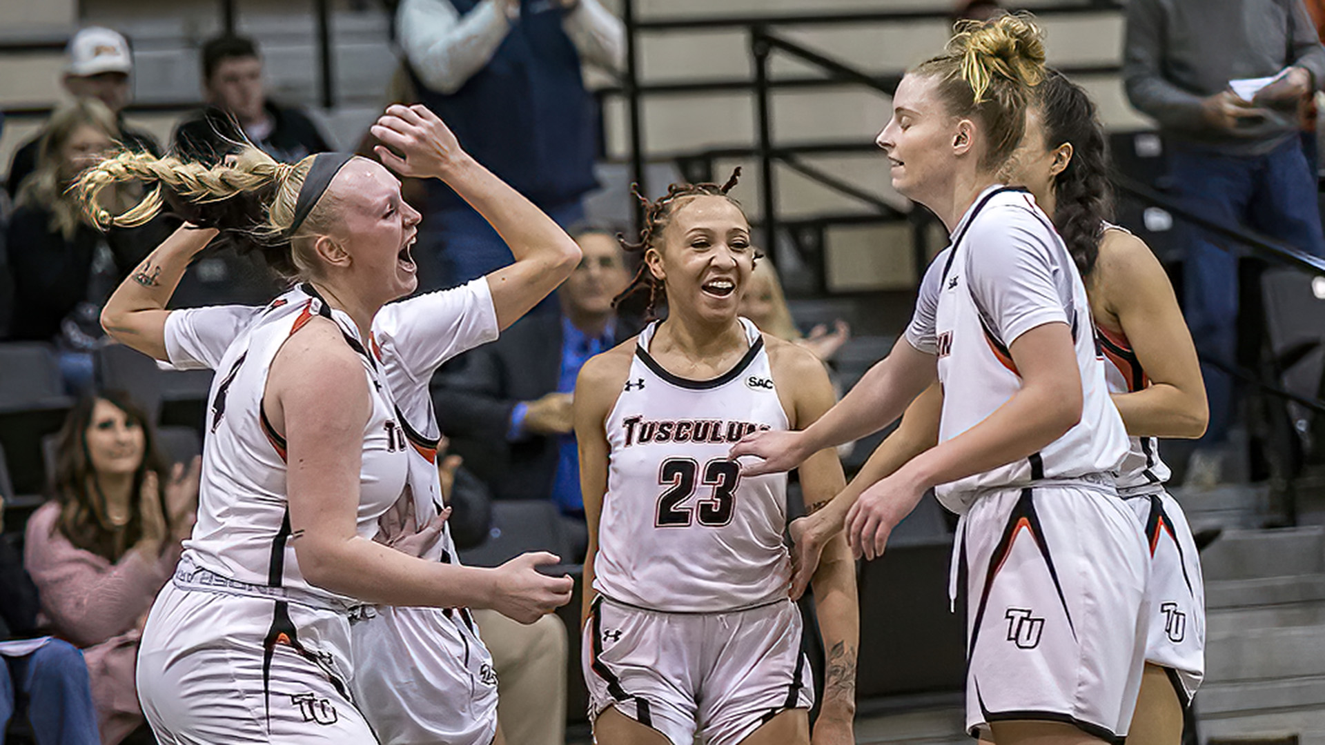 From left, Jenna Kallenberg, Mya Belton and Alyssa Walker celebrate as the Pioneers pick up a 54-38 win over 4th-ranked North Georgia (photo by Chuck Williams)