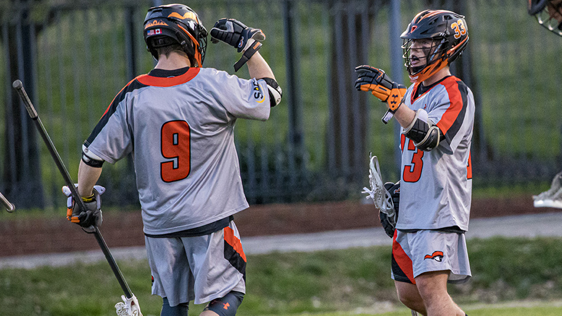 Kale Lawrence receives congratulations from Joel Edgar after one of his six second-quarter goals against Lees-McRae (photo by Chuck Williams)