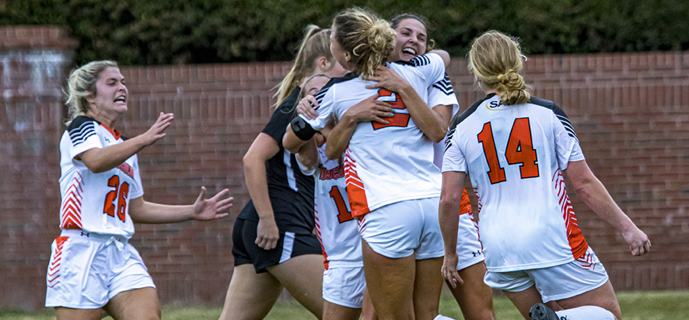 Kenzie Ellenburg is mobbed by her teammates after scoring in the 75th minute of the Pioneers' 1-0 win over Anderson (photo by Chuck Williams)
