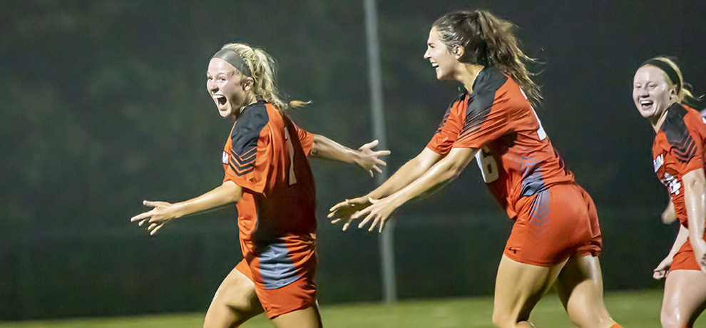 Ellie Tomassoni celebrates her go-ahead goal against Young Harris with teammates Kate Guildford and Kaitlyn Watson (photo by Chuck Williams)