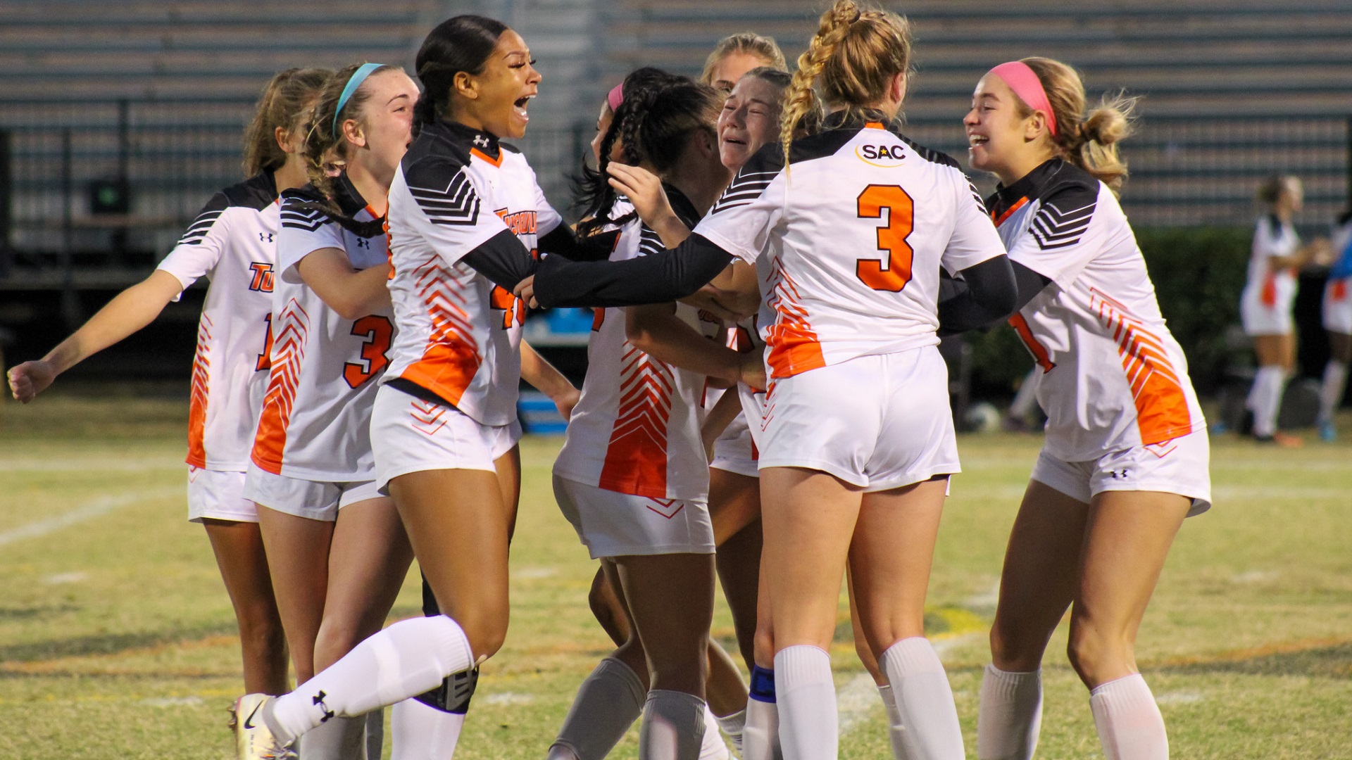 Chayse Stonebraker is surrounded by her teammates after scoring the tying goal (photo by student photographer Kari Ham)